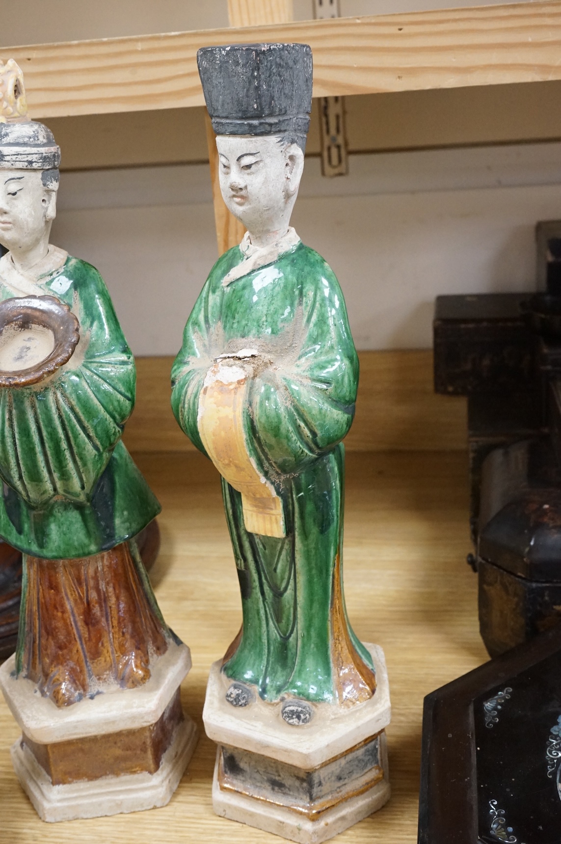 Three Chinese Ming sancai glazed figures of attendants, tallest figure 46cm